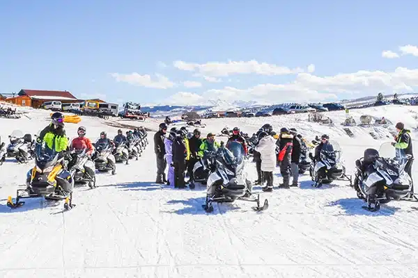 Anywhere 19-2×3 A group of people prepare to go to snow mobiling