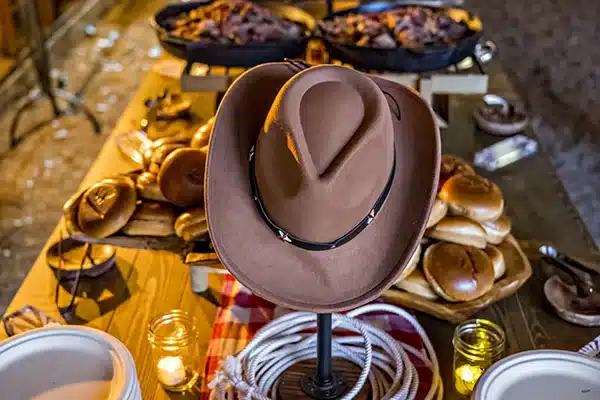 Anywhere 3-2×3 A cowboy hat is the focal point of a catering banquet table