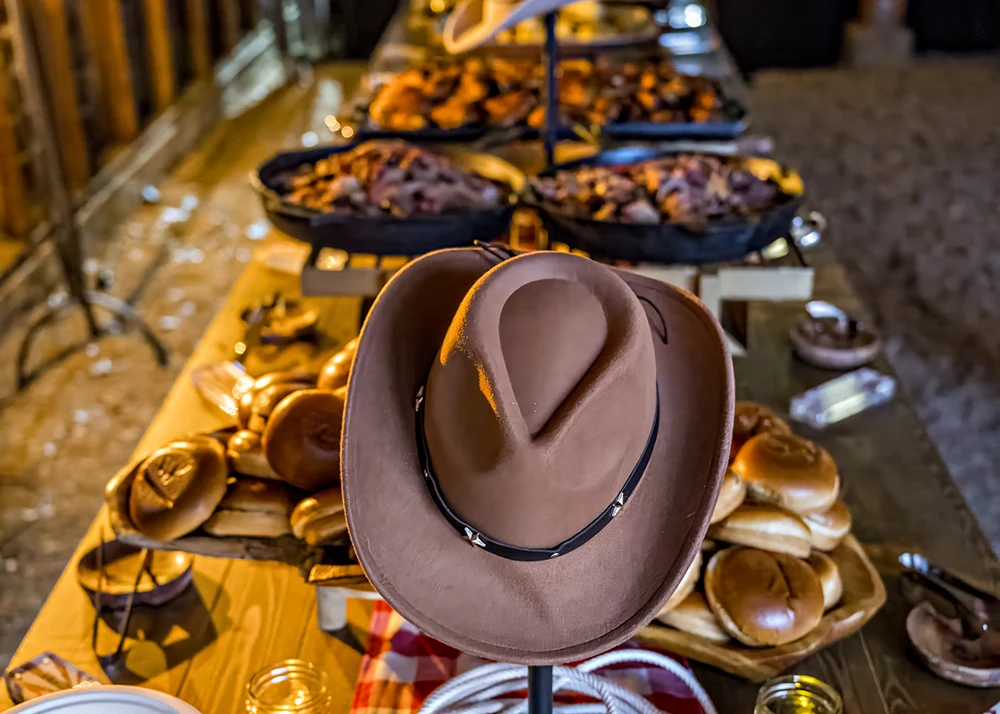 Anywhere 3 A cowboy hat is the focal point of a catering banquet table