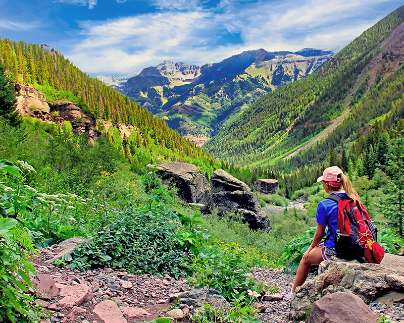 telluride_556514744 a hiker rests near Telluride, Colorado