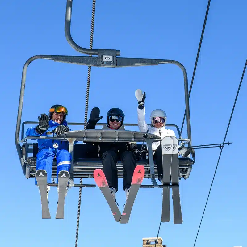 Steamboat 2 A group of people wave from a ski lift